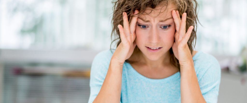 women with her head in her hands, showing she is stressed